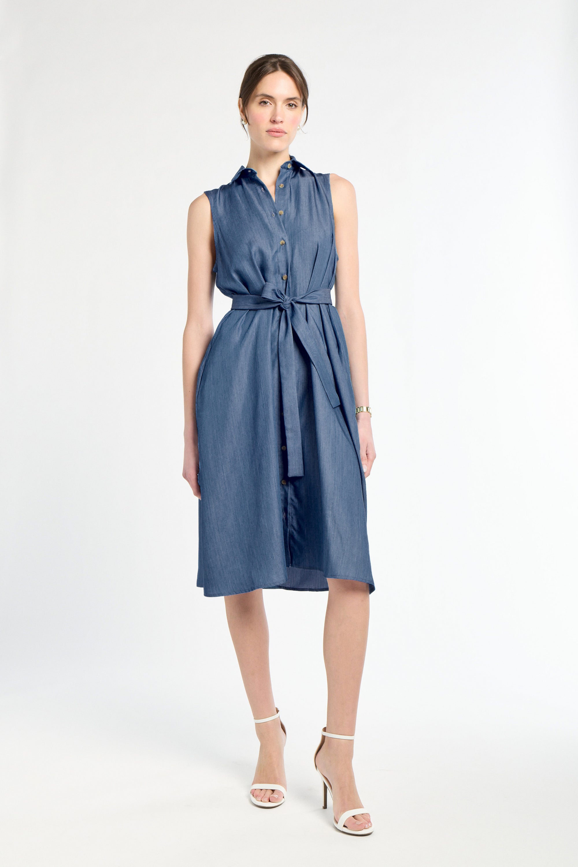 Woman wearing a blue dress with a white background