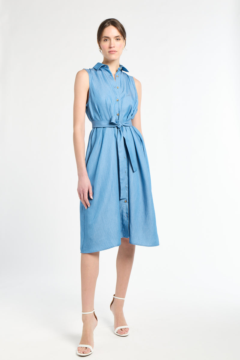 Woman modeling a sleeveless blue dress against a white background