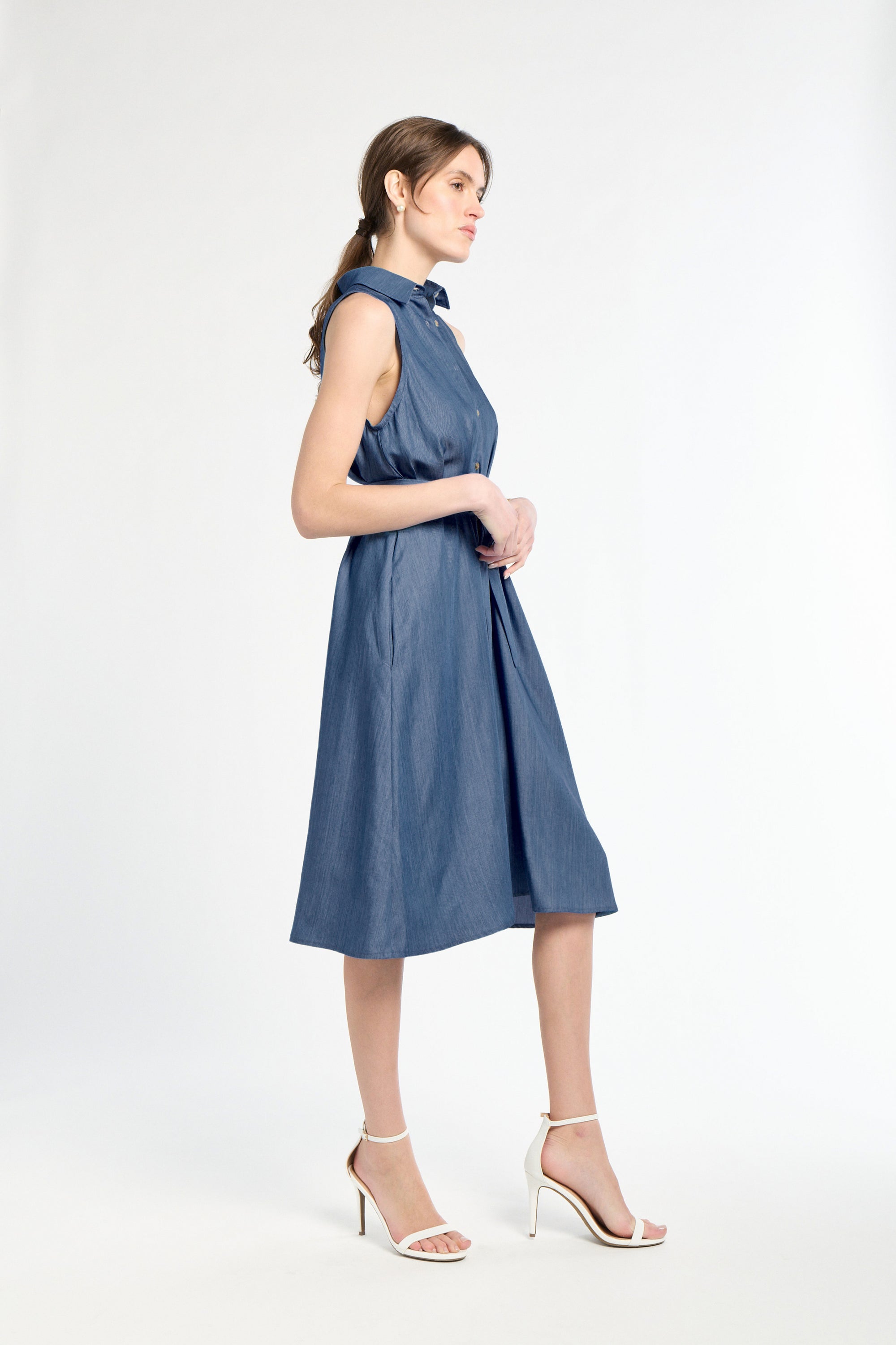 Woman wearing a blue dress on a white background