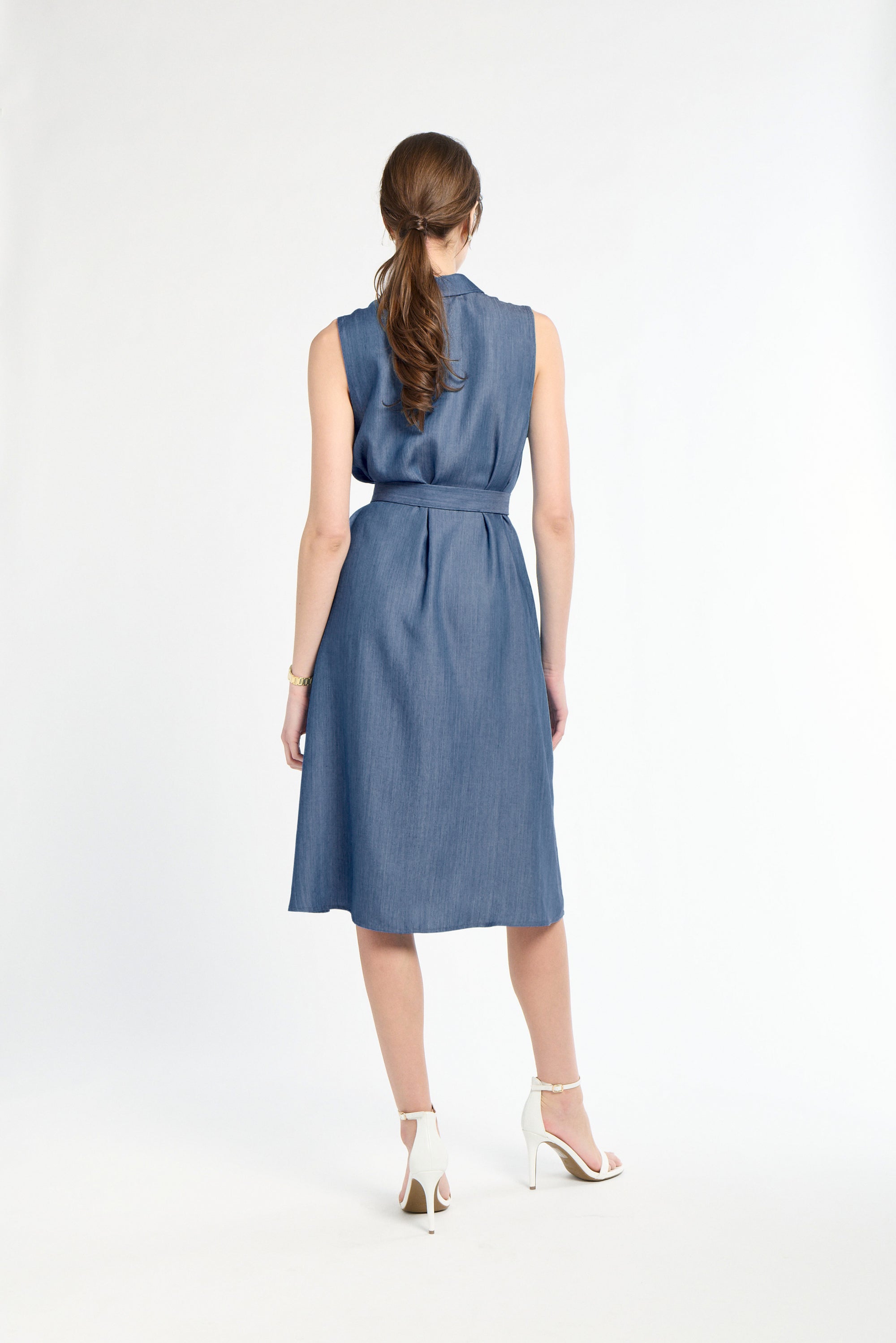 Woman wearing a blue dress on a white background