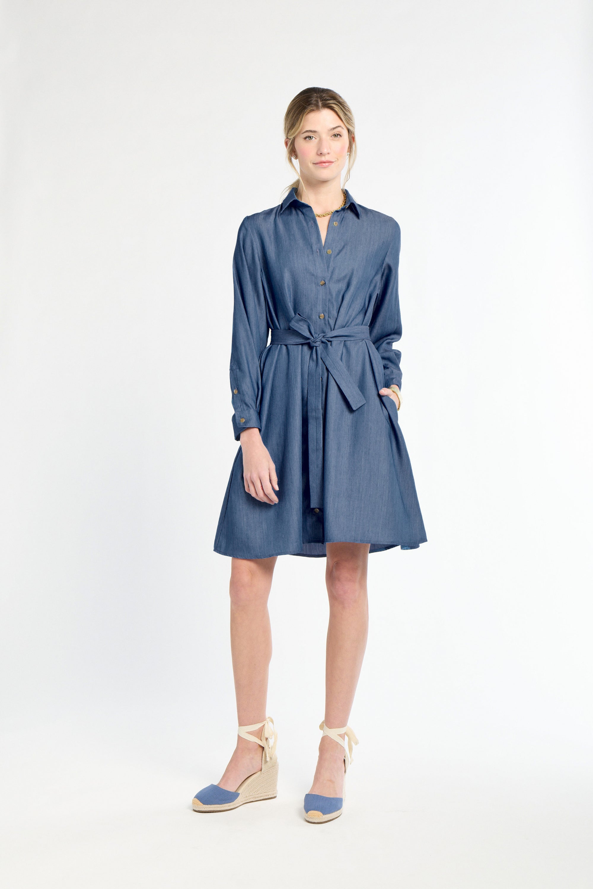 Woman wearing a blue dress on a white background