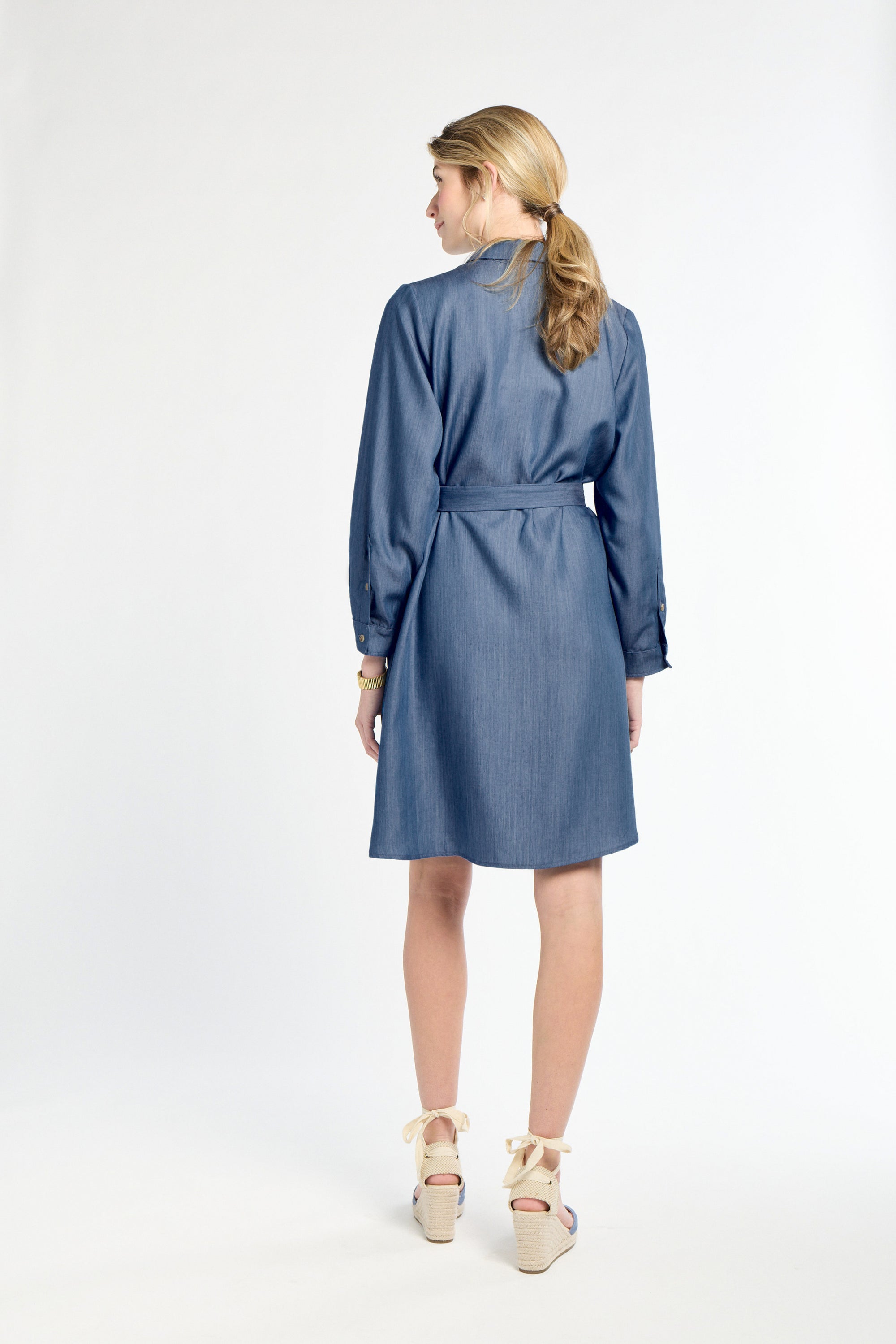 Woman wearing a blue dress on a white background