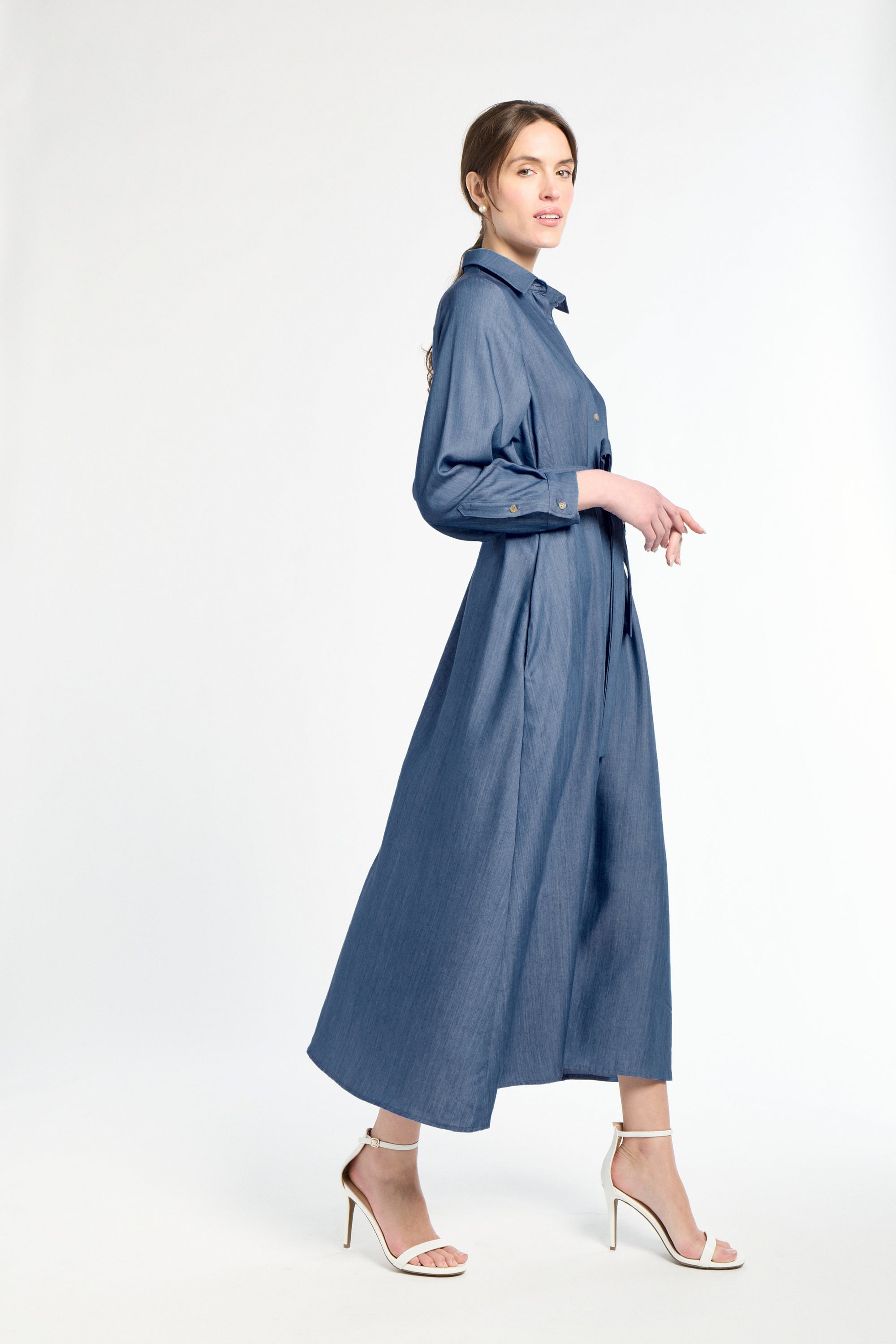 Woman wearing a blue dress on a white background