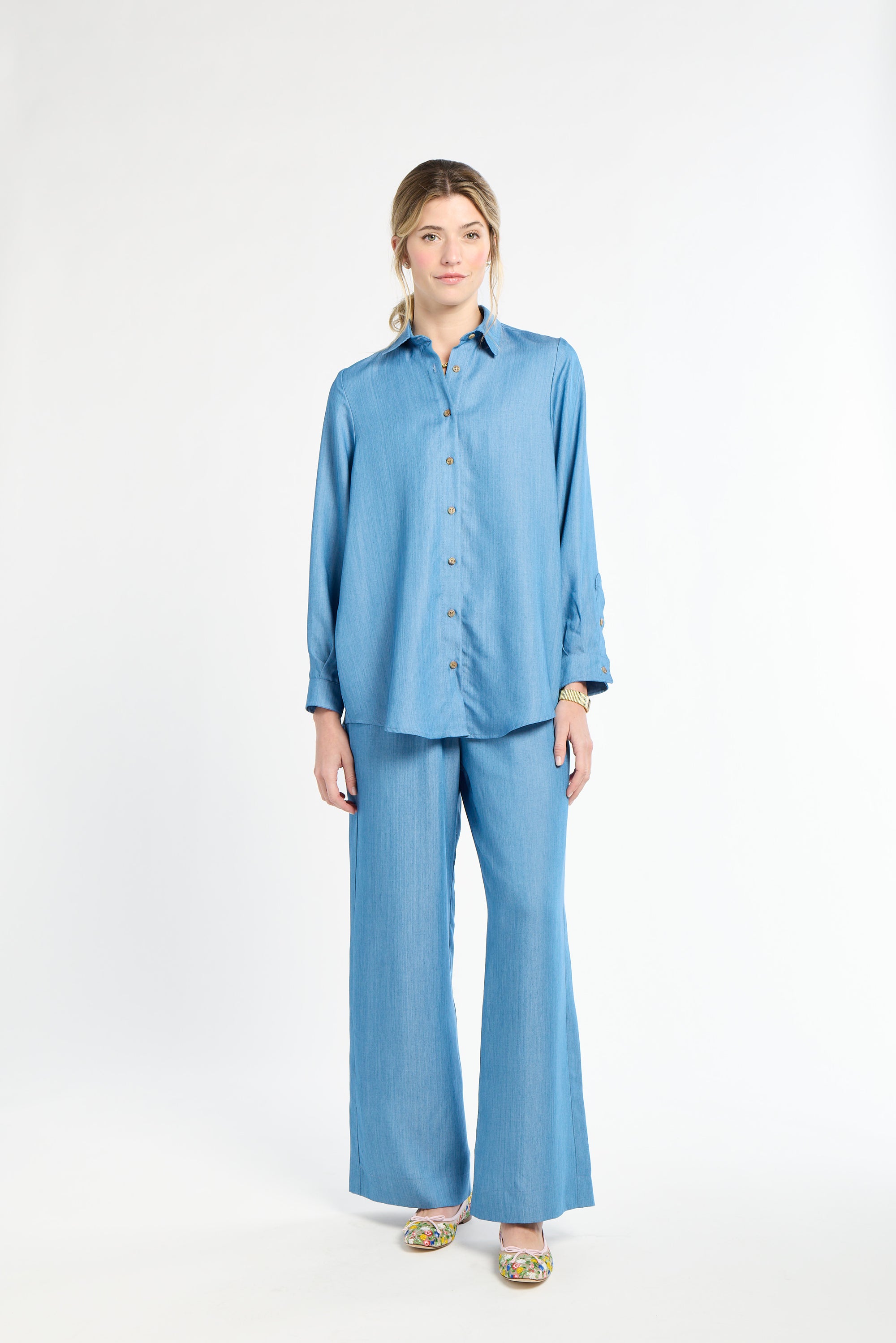 Woman wearing a blue outfit on a white background