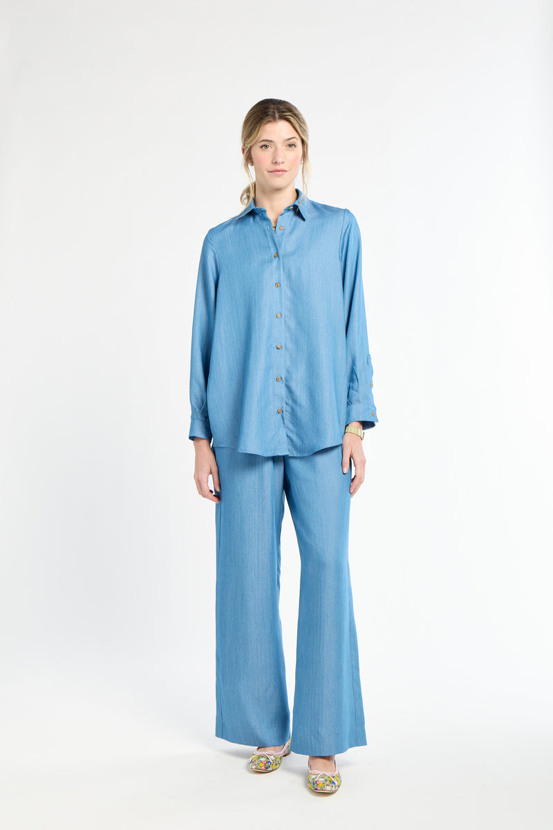 Woman wearing a blue outfit on a white background