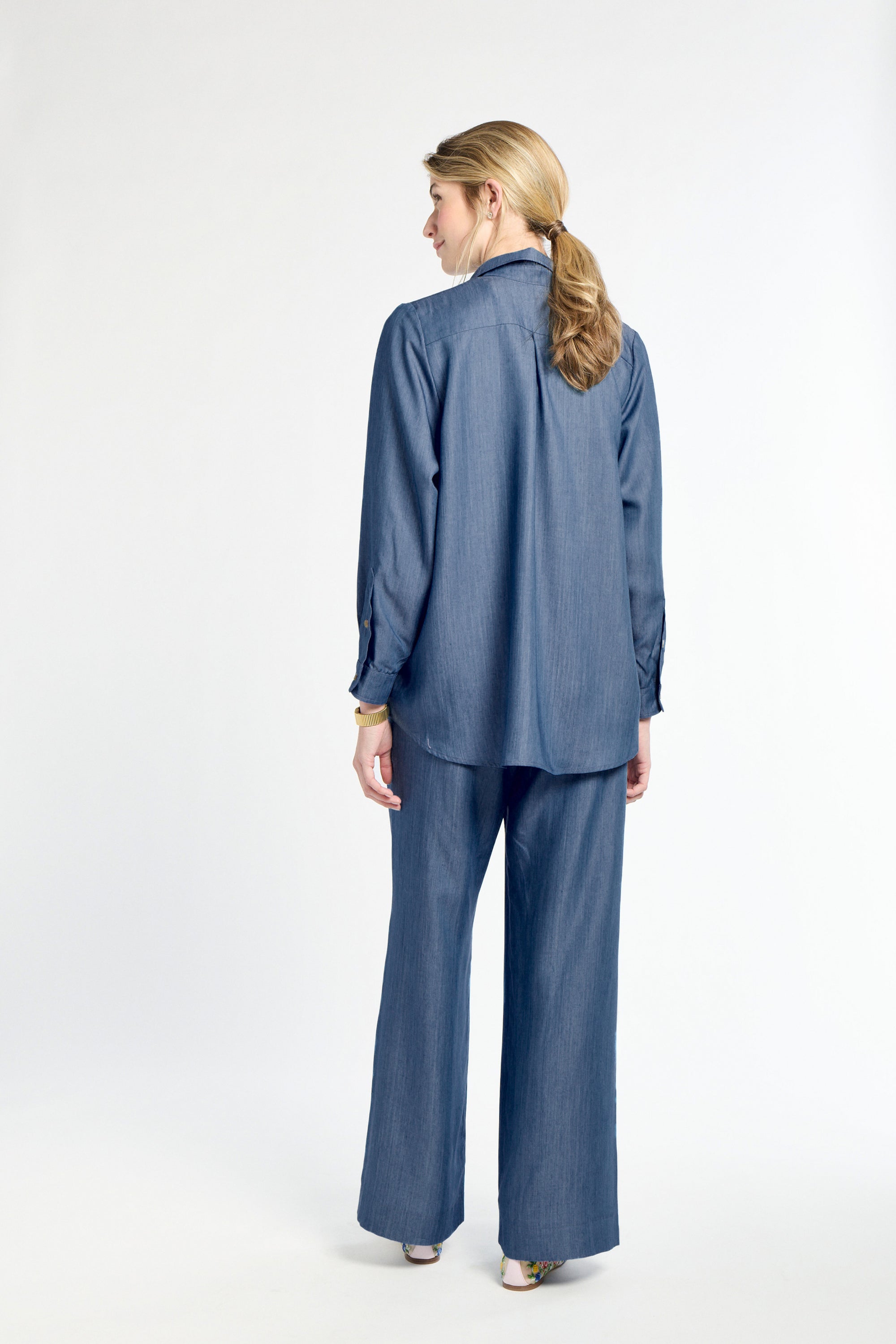 Woman wearing a blue outfit on a white background