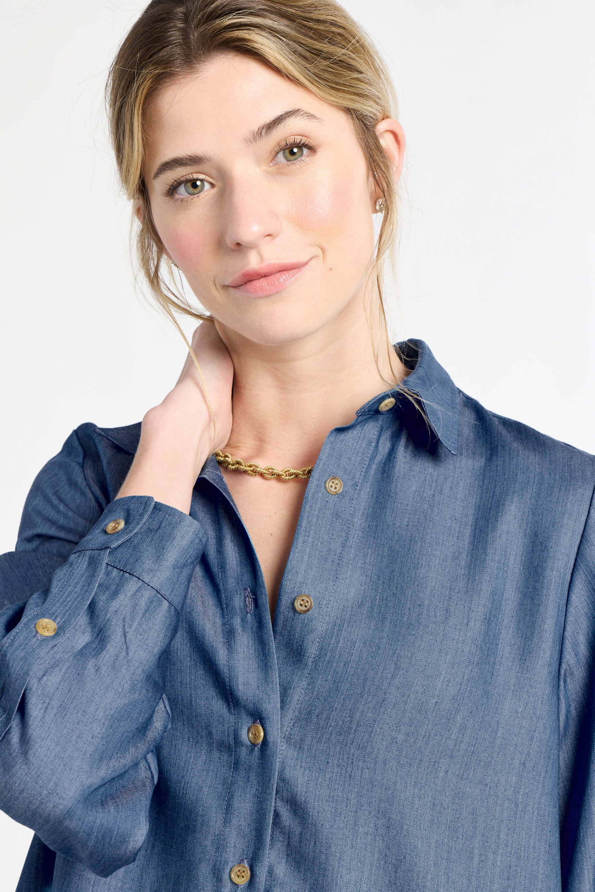 Woman wearing a blue shirt with a plain background