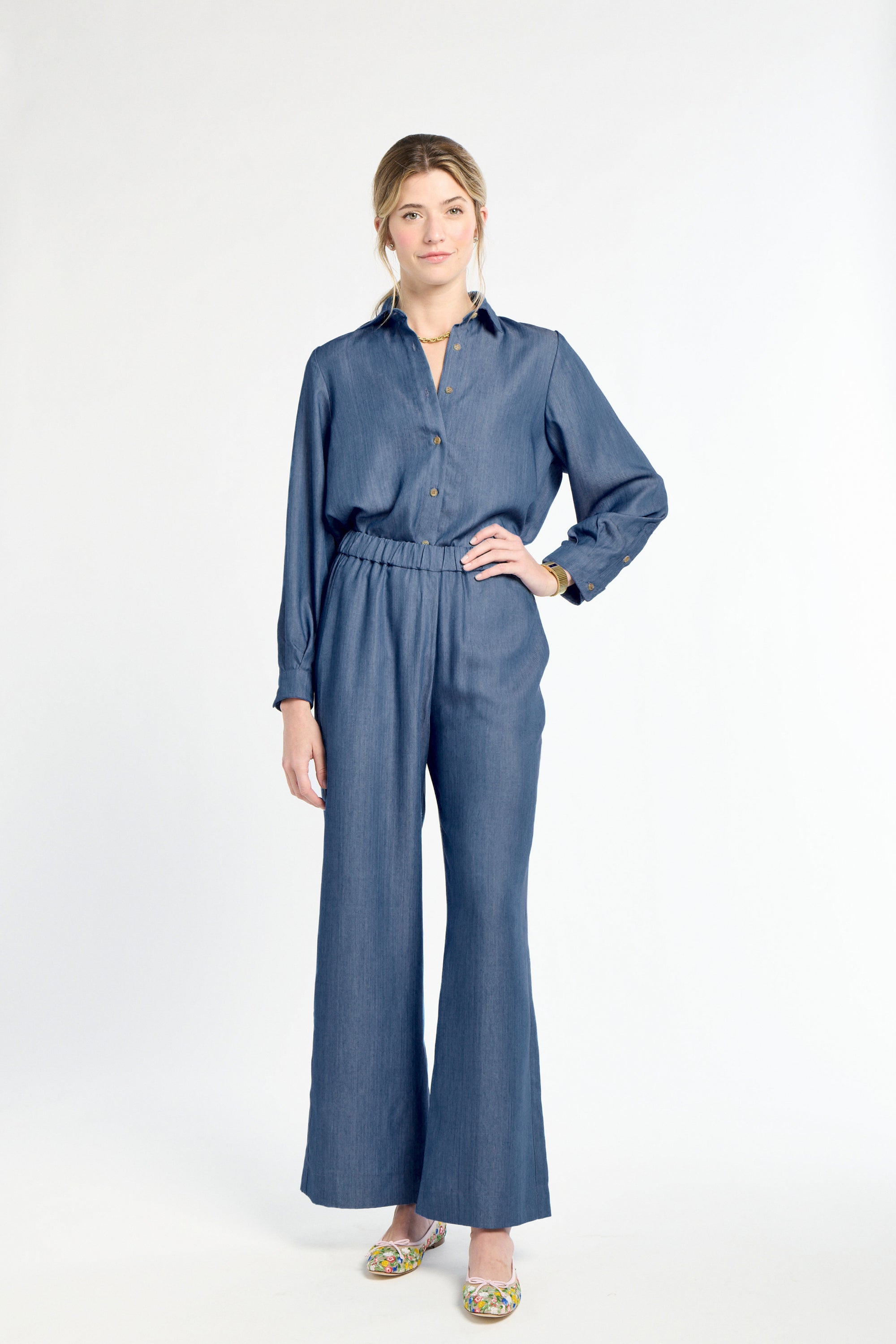 Woman wearing a blue jumpsuit on a white background