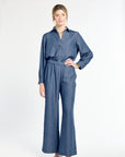 Woman wearing a blue jumpsuit on a white background