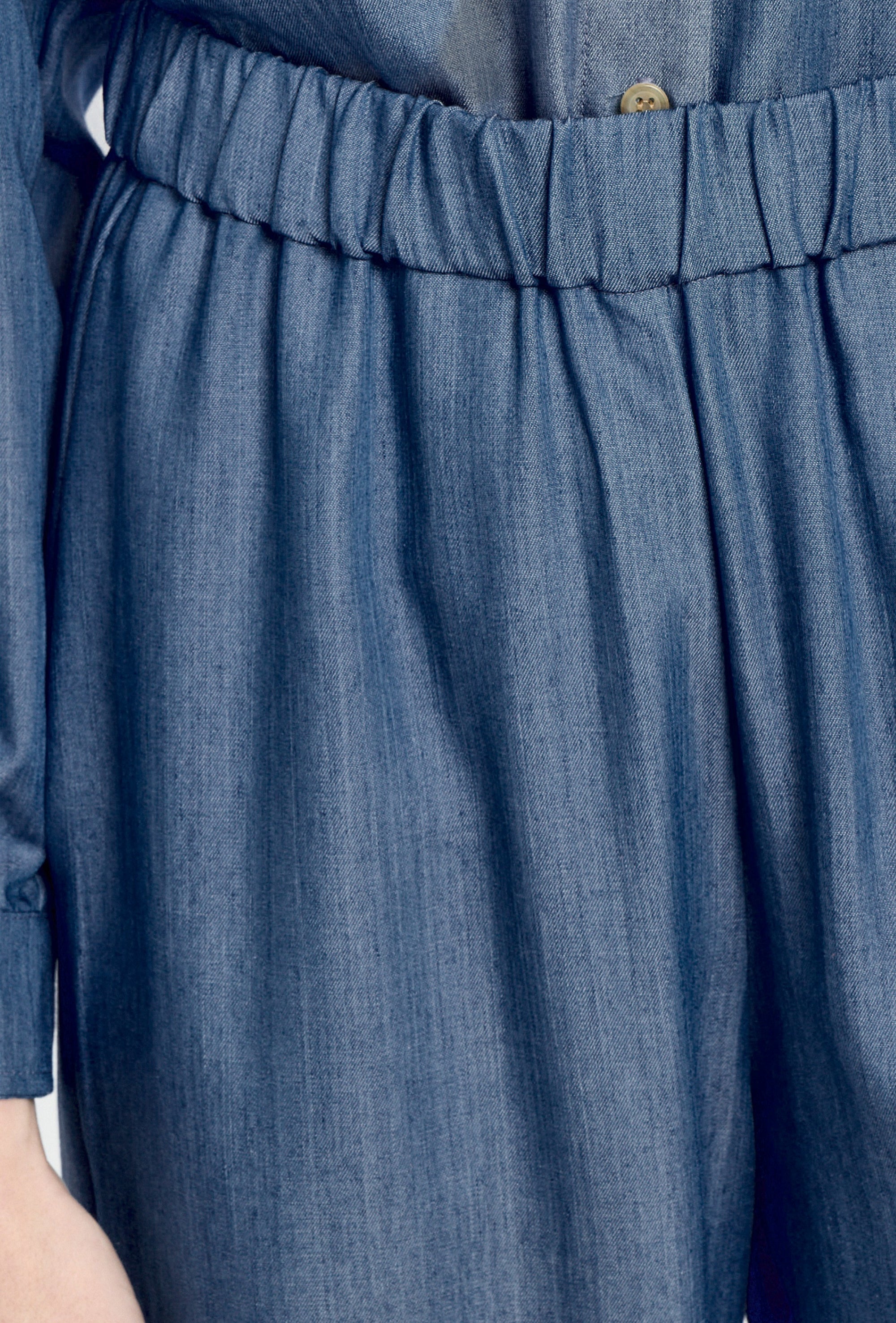 Close-up of blue denim pants with an elastic waistband