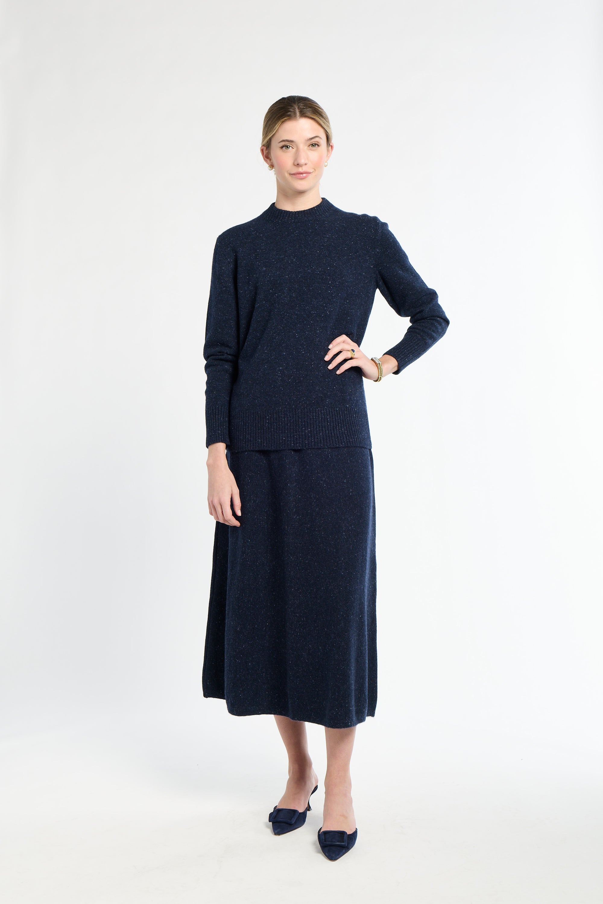 Woman wearing a navy blue outfit on a white background