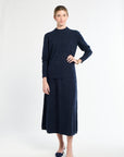 Woman wearing a navy blue outfit on a white background