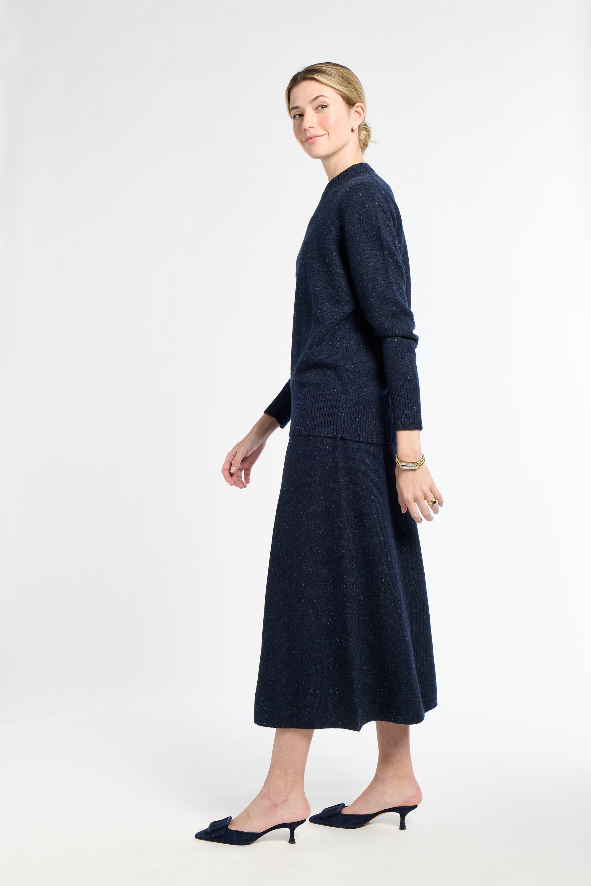 Woman wearing a navy blue outfit on a white background