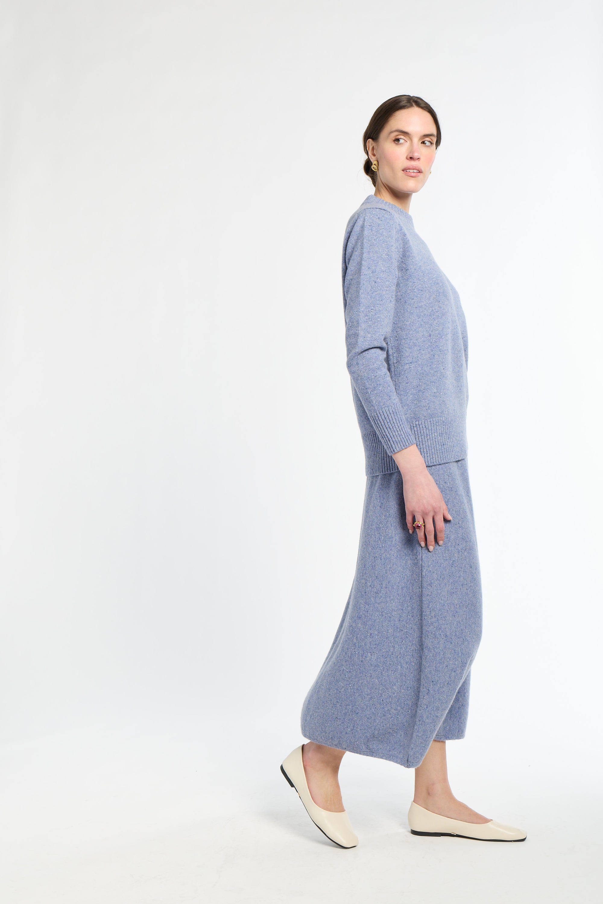 Woman wearing a light blue dress on a white background