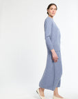 Woman wearing a light blue dress on a white background