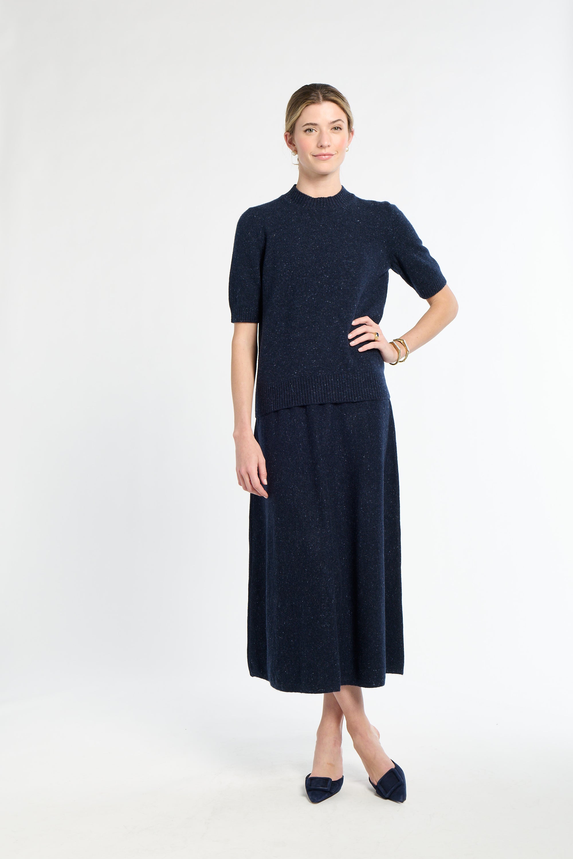 Woman wearing a navy blue dress with a white background