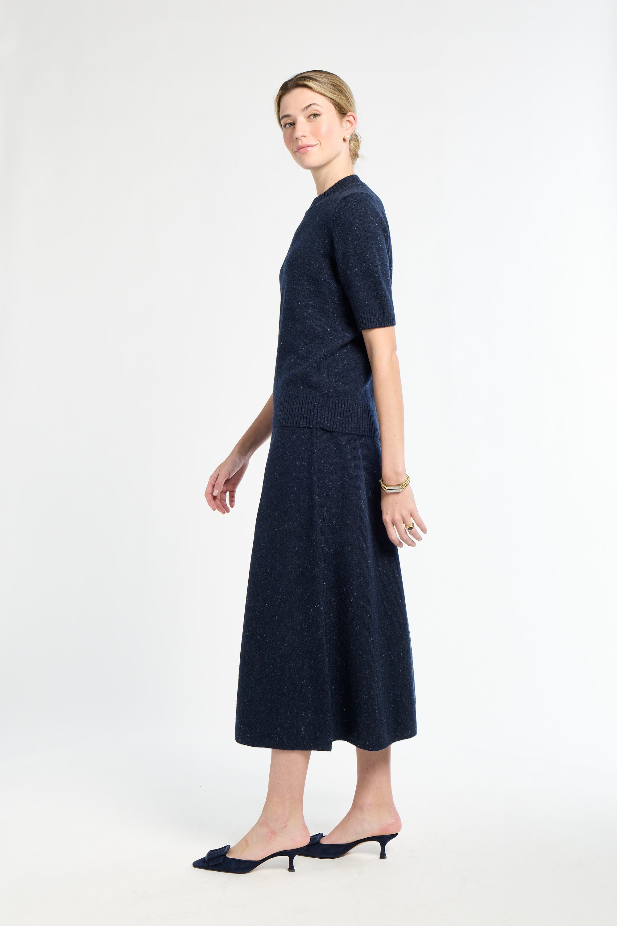 Woman wearing a navy blue dress on a white background