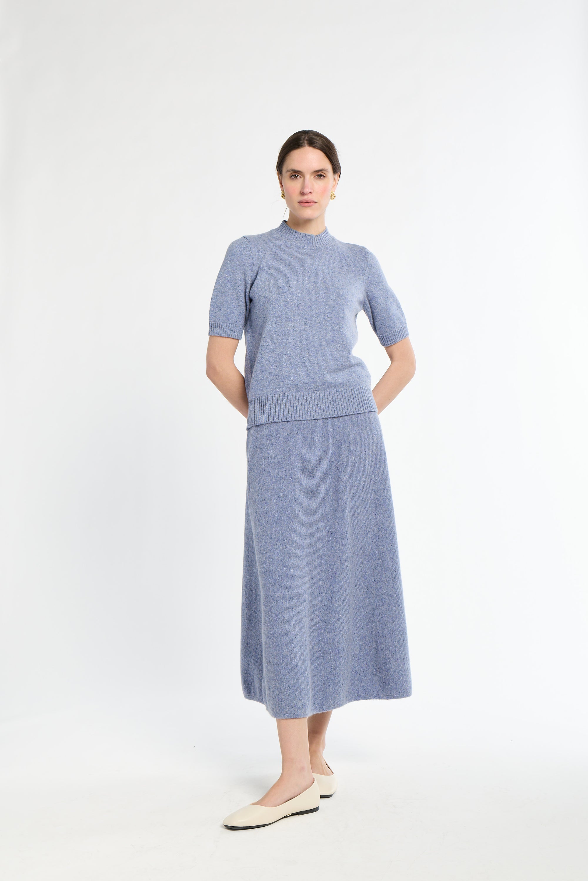 Woman wearing a blue dress with a white background