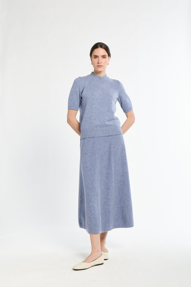 Woman wearing a blue dress with a white background