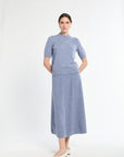 Woman wearing a blue dress with a white background