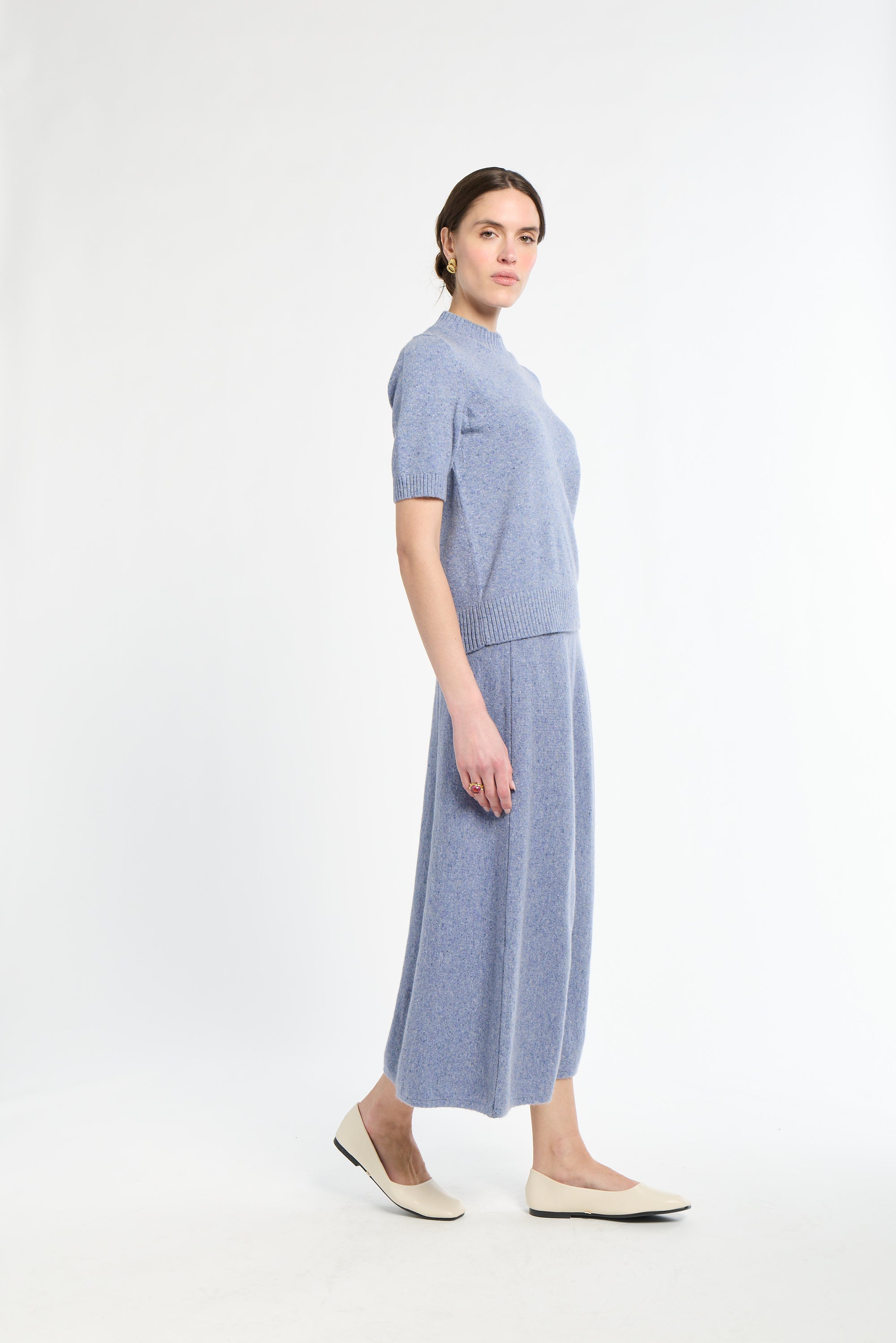 Woman wearing a blue dress on a white background