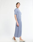Woman wearing a blue dress on a white background