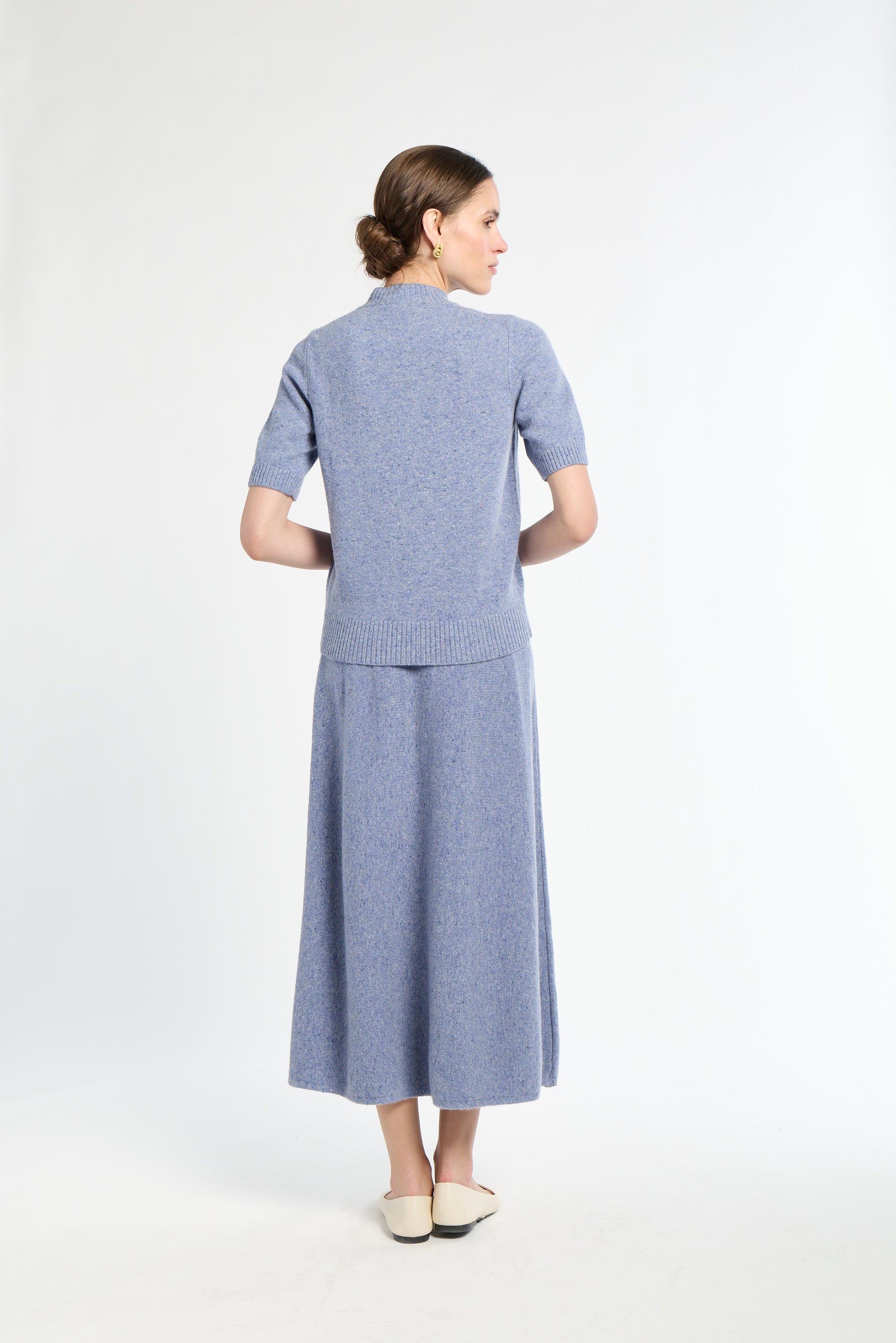 Woman wearing a blue outfit on a white background