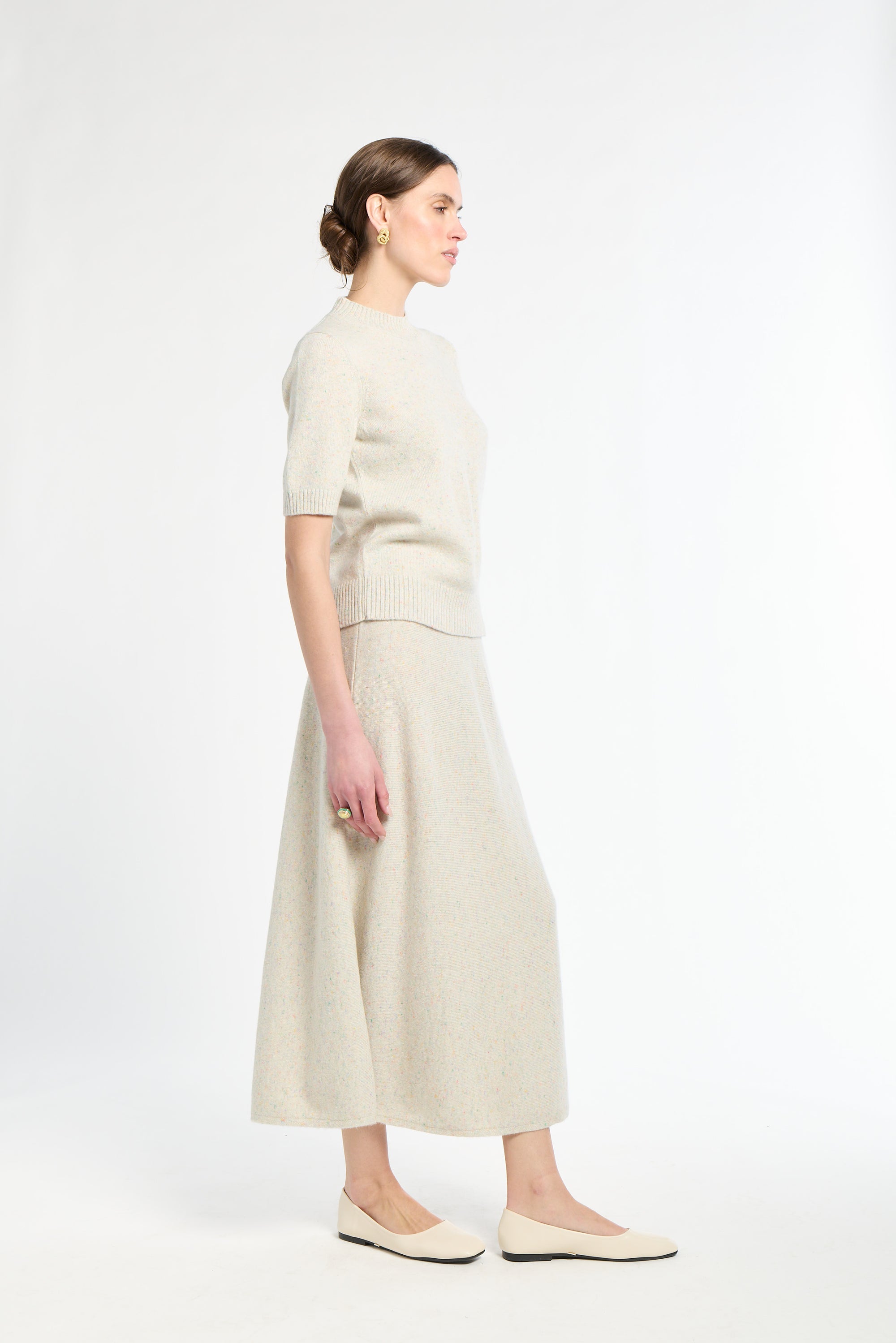 Woman wearing a beige outfit on a white background