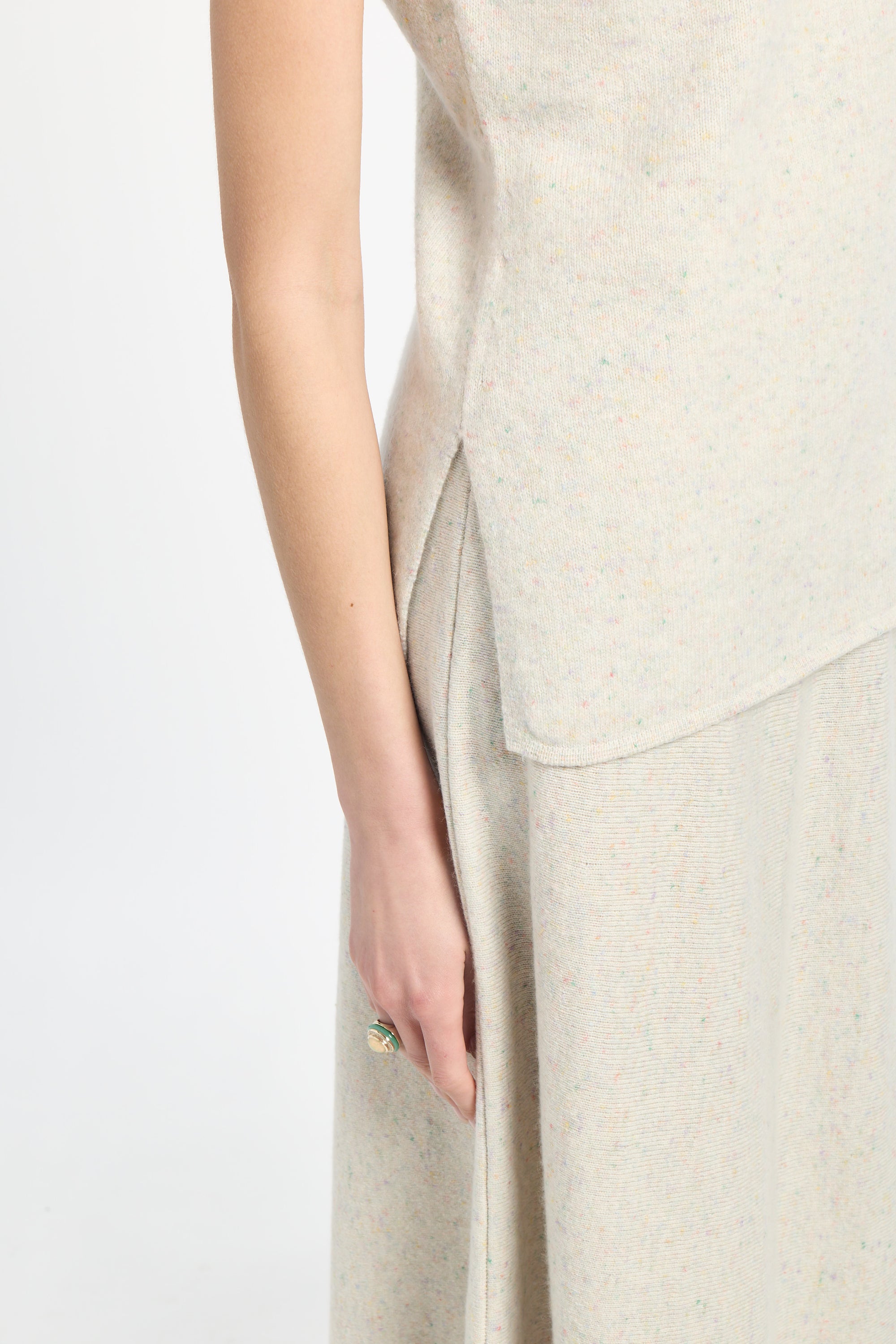 Beige sleeveless top and pants on a white background