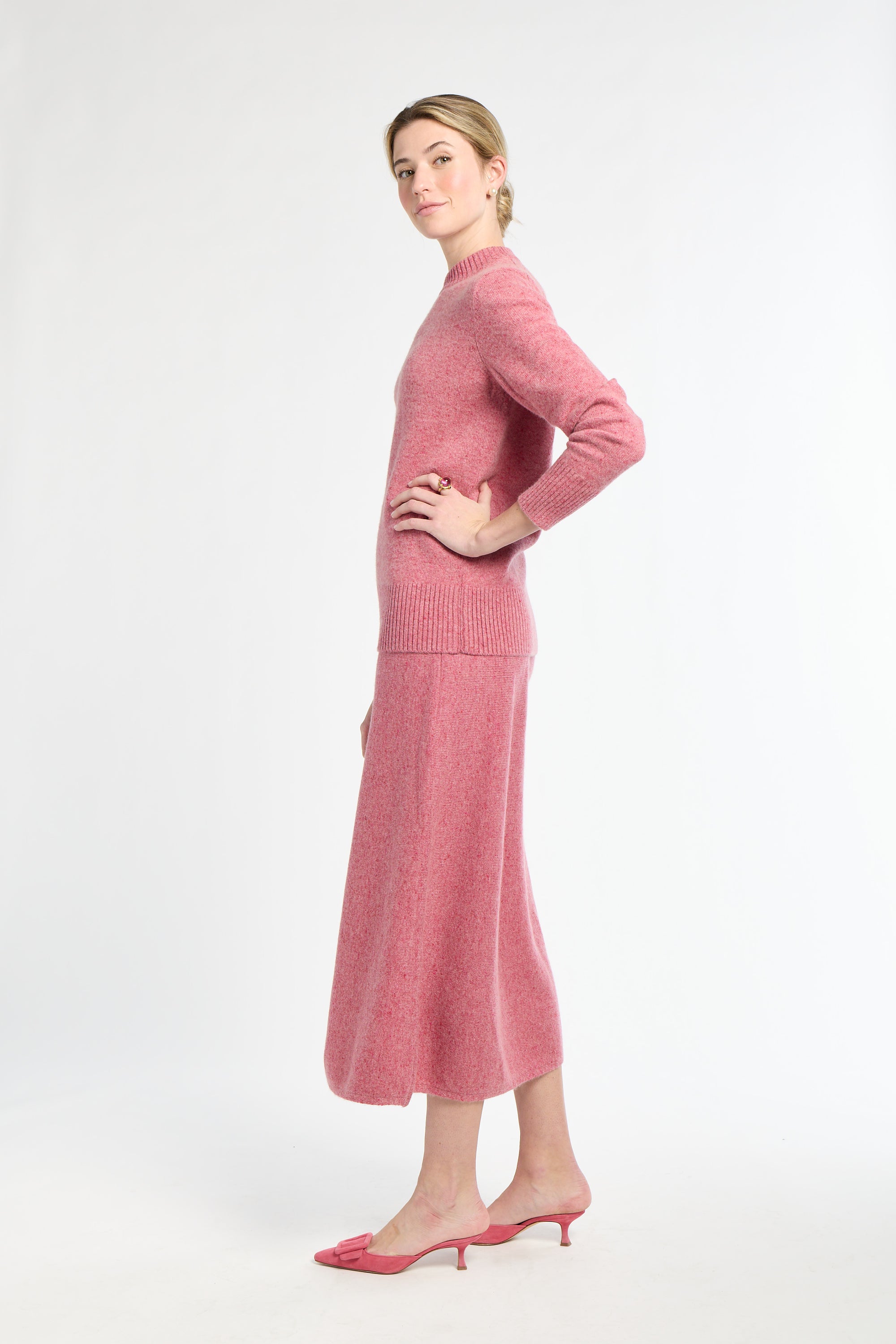 Woman wearing a pink outfit on a white background