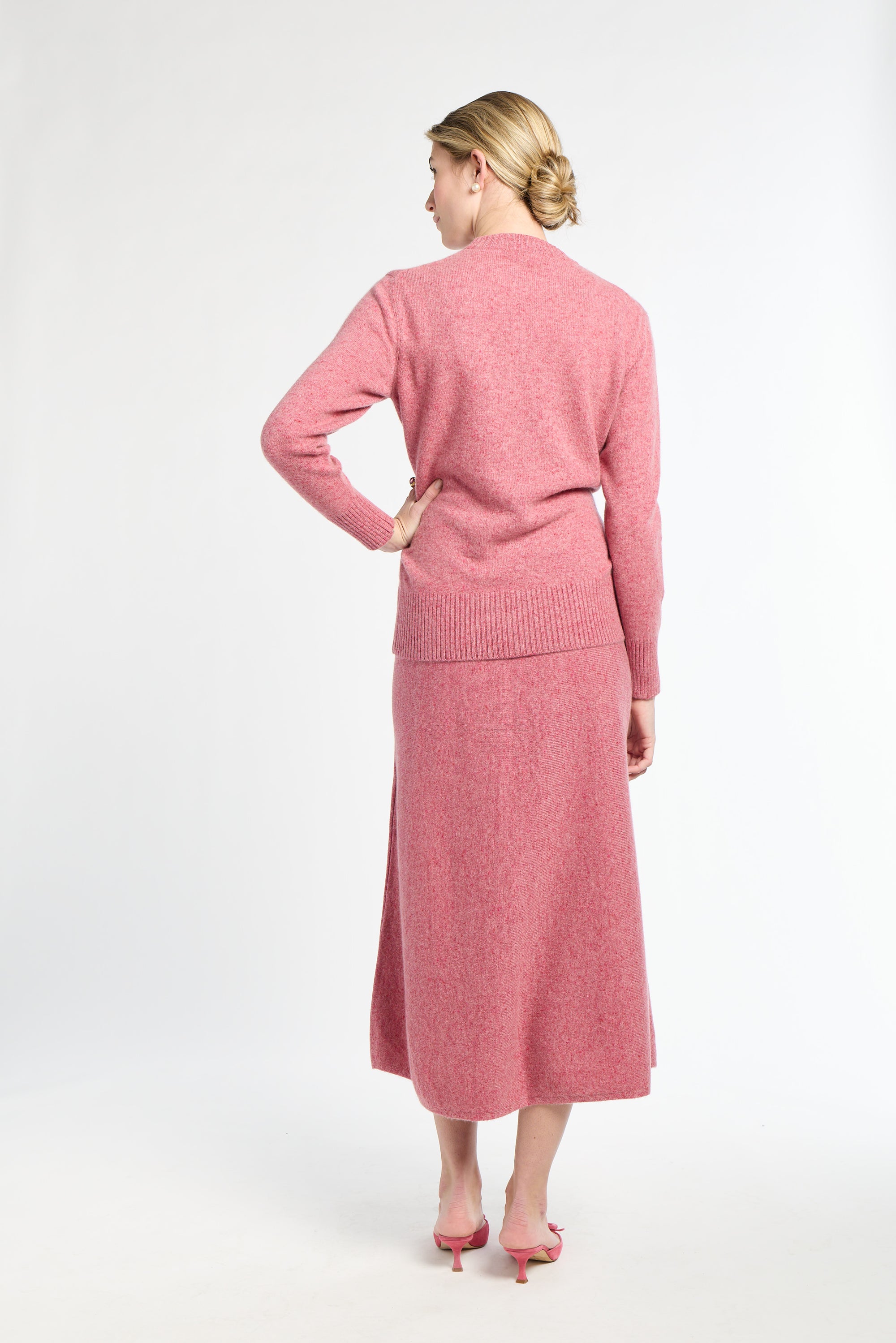 Woman wearing a pink outfit on a white background