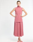 Woman wearing a pink dress on a white background