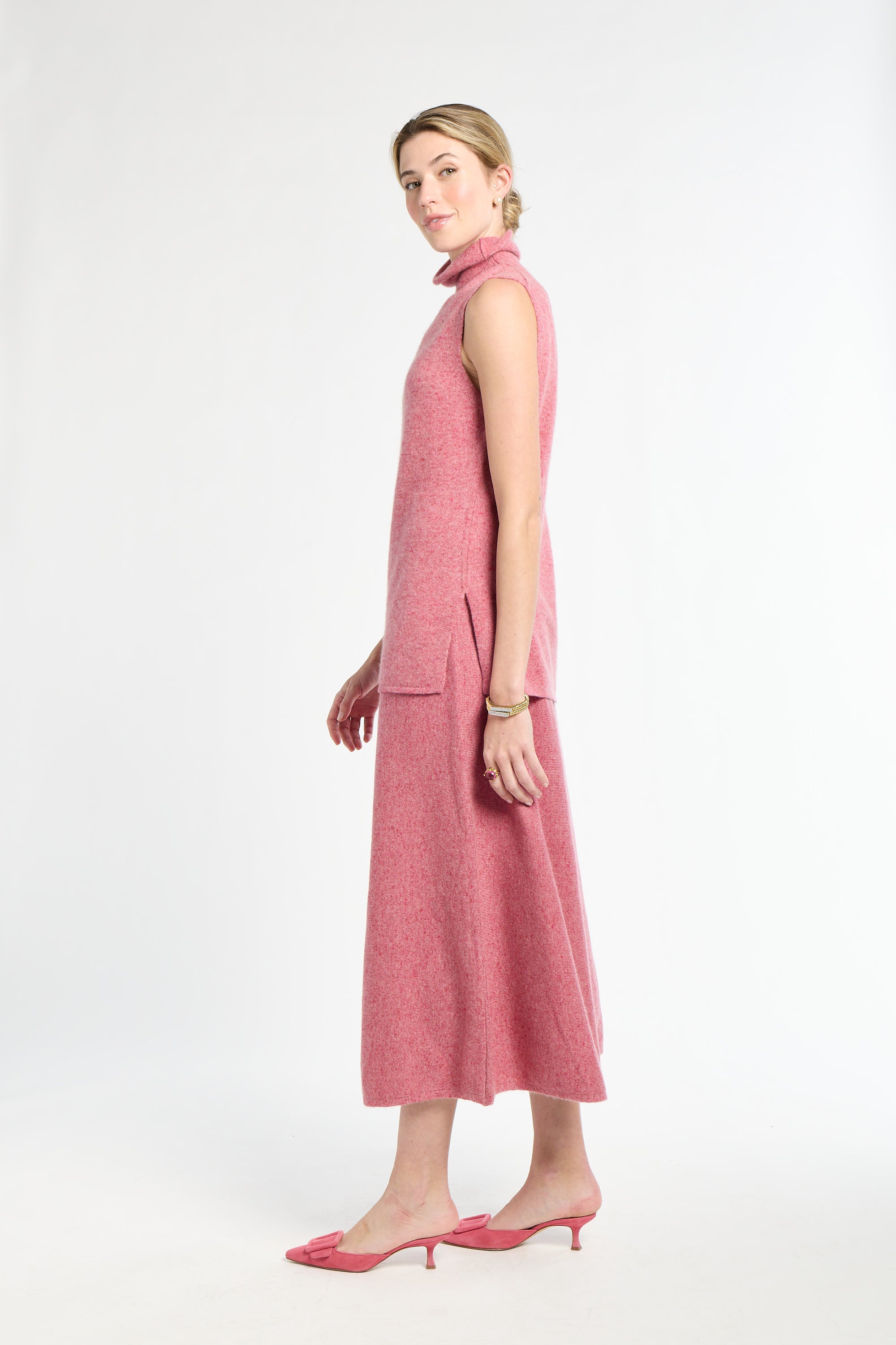 Woman wearing a pink sleeveless dress on a white background