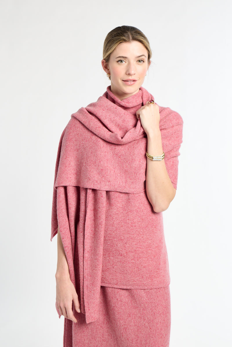 Woman wearing a pink scarf and dress against a white background