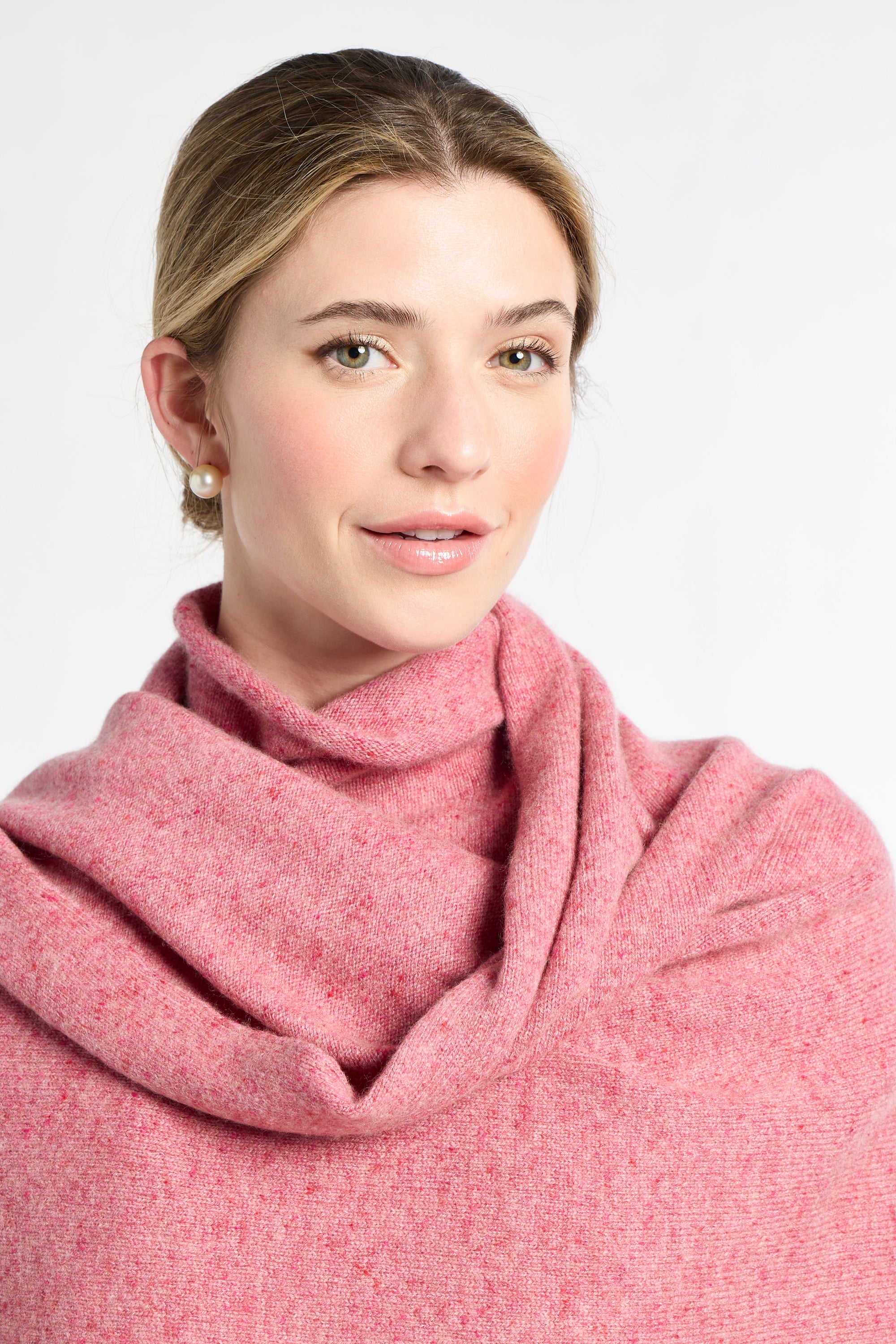 Woman wearing a pink scarf on a white background