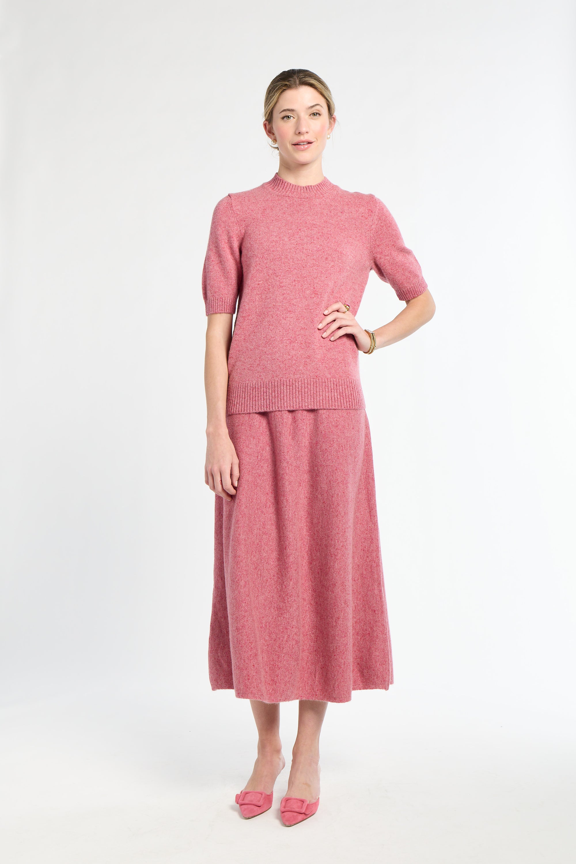 Woman wearing a pink outfit on a white background