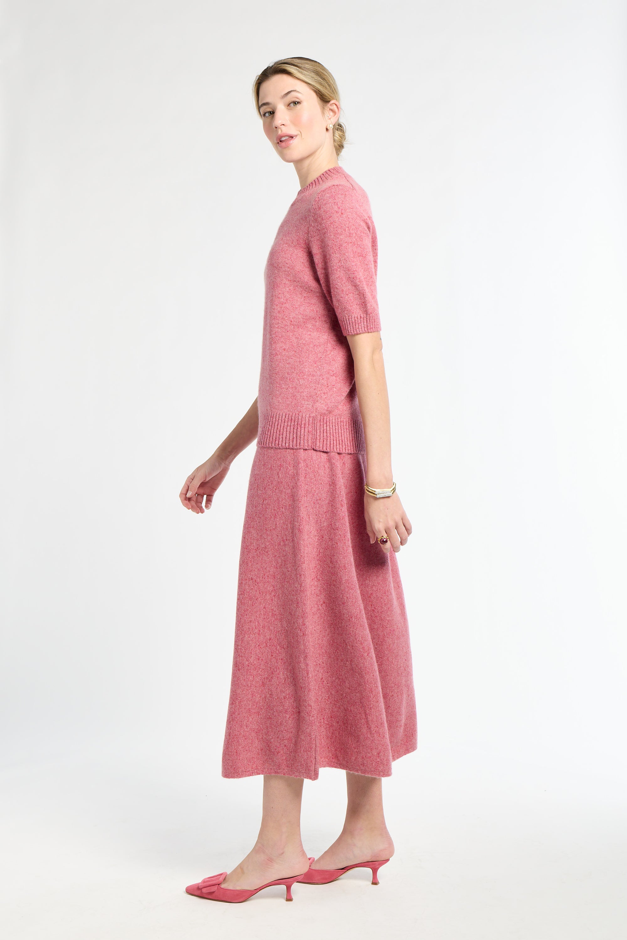 Woman wearing a pink outfit on a white background