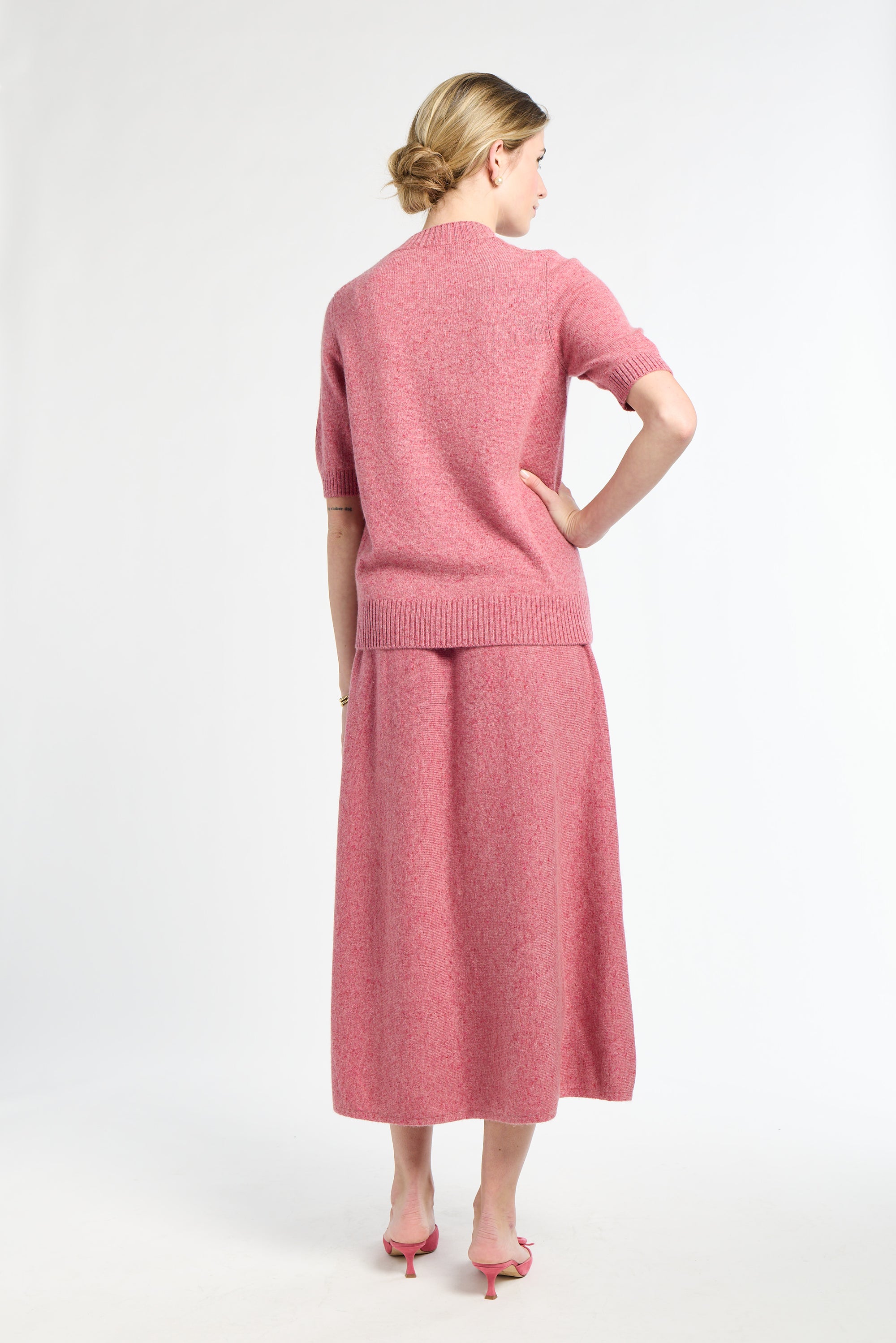 Woman wearing a pink outfit on a white background
