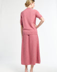 Woman wearing a pink outfit on a white background