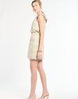 Side shot of woman wearing a sleeveless tweed top paired with a tweed mini skirt on a white background