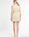 Back of woman wearing a sleeveless golden tweed top paired with a tweed mini skirt on a white background