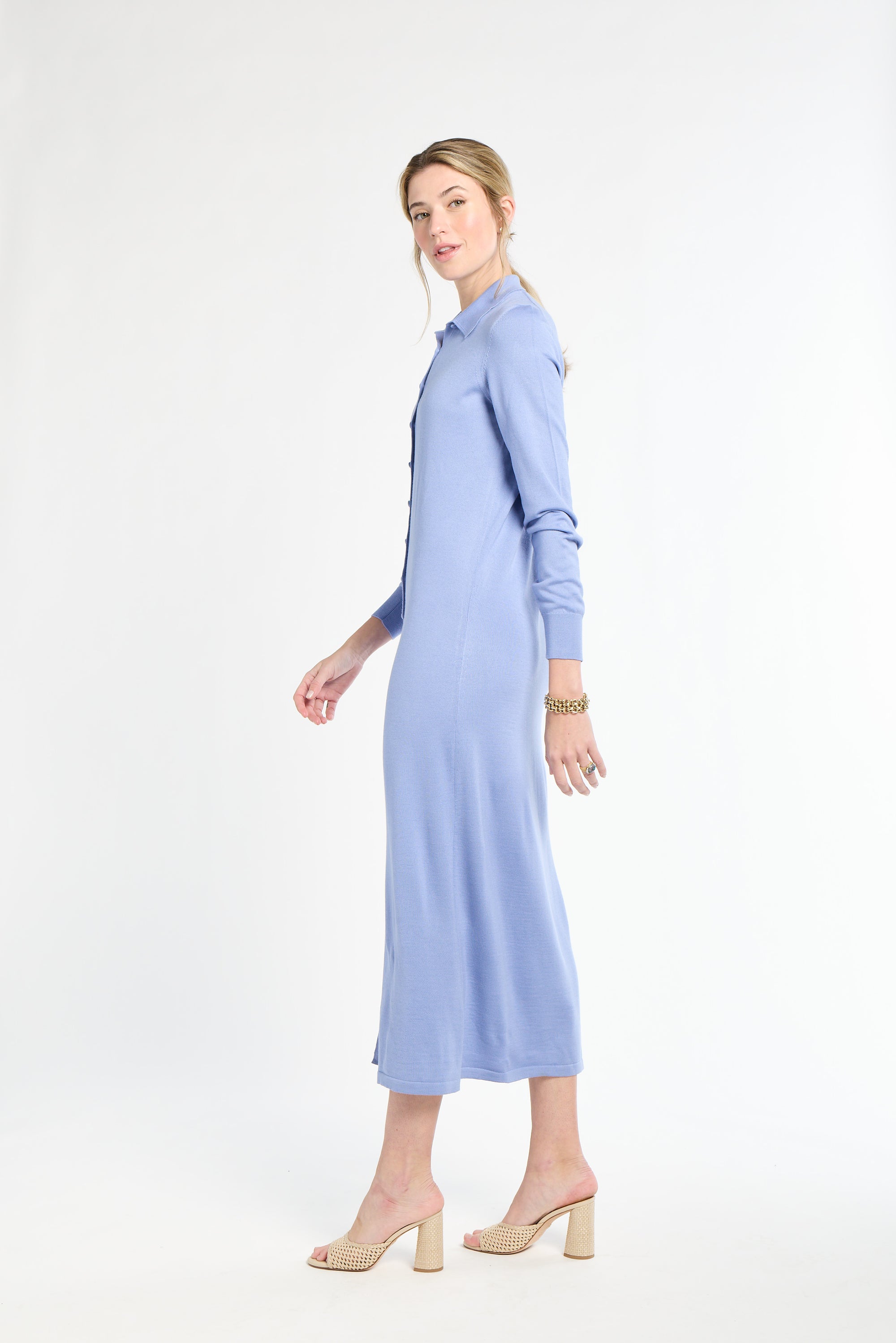 Woman wearing a light blue dress on a white background