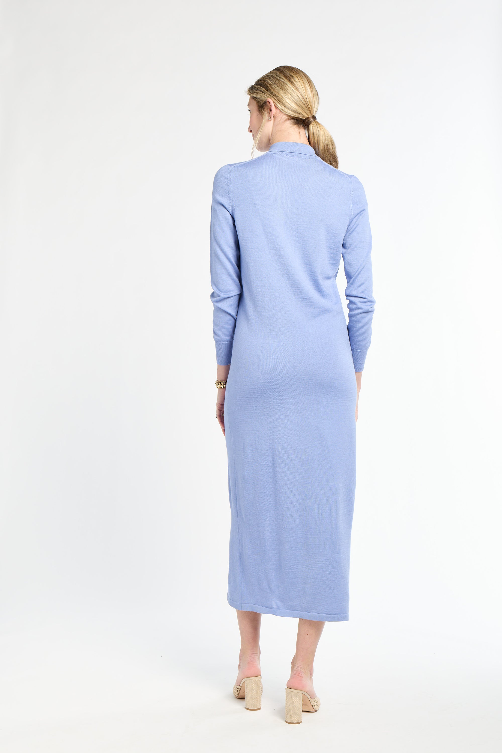 Woman wearing a light blue dress on a white background