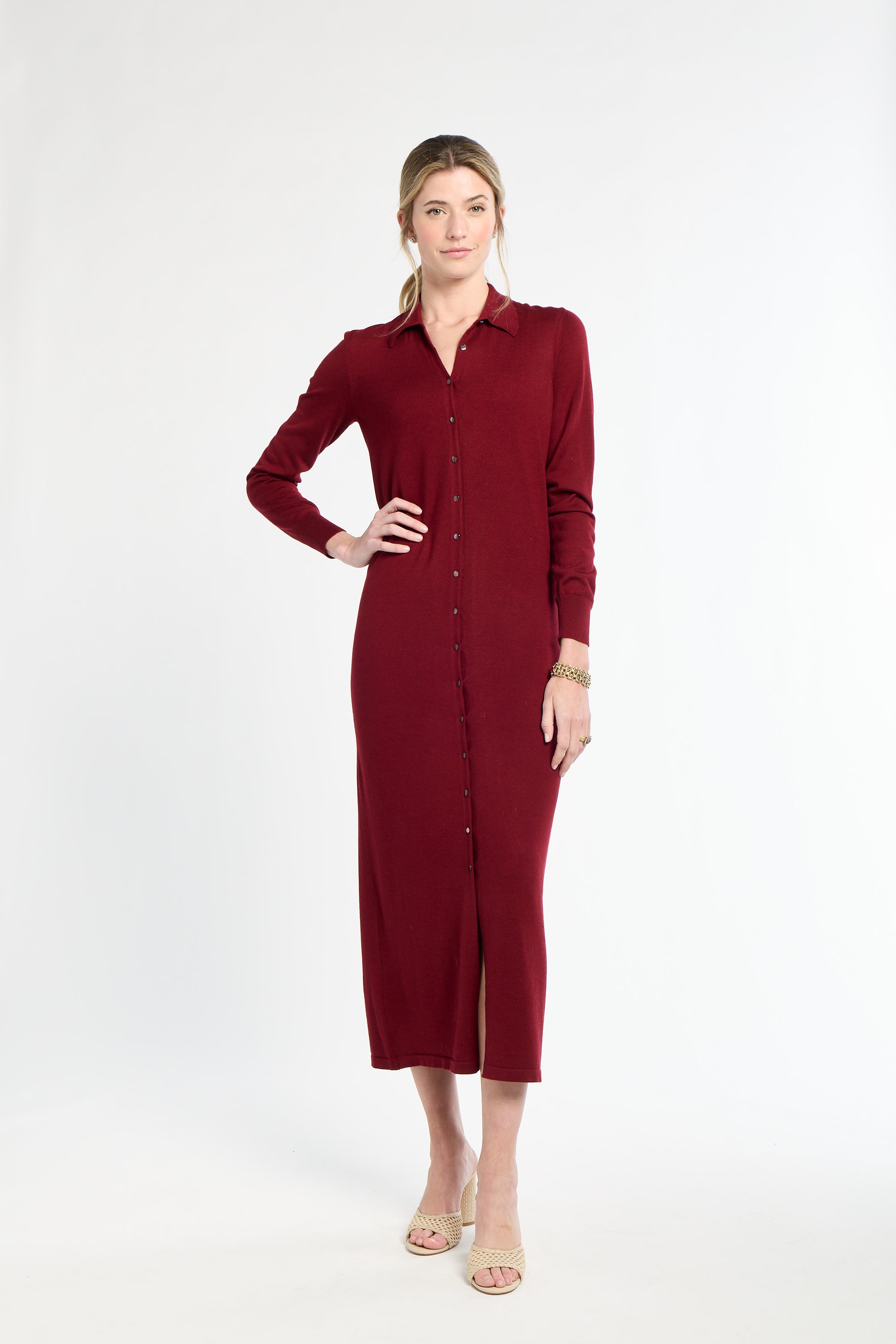 Woman wearing a burgundy dress on a white background