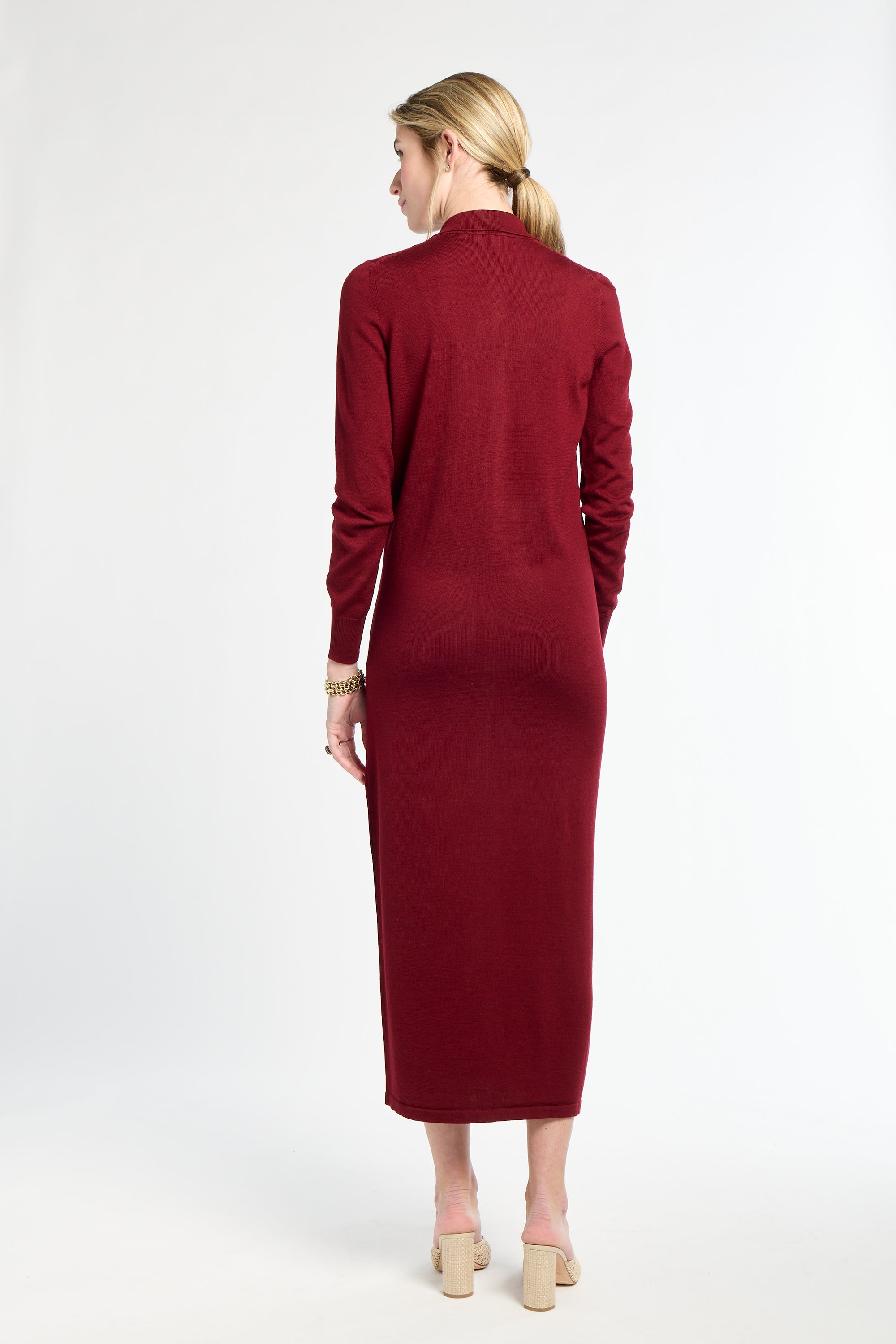 Woman wearing a burgundy dress on a white background