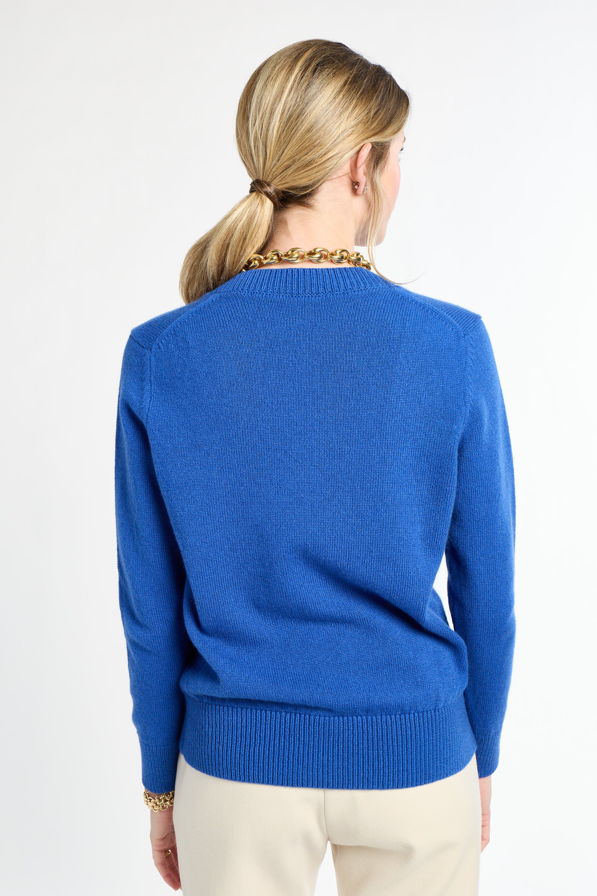 Person wearing a blue sweater on a white background