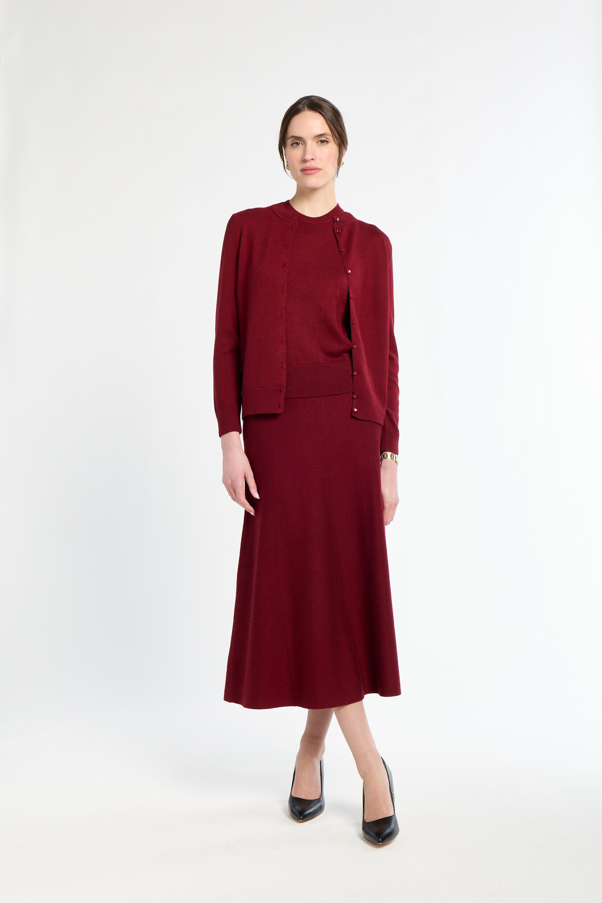 Woman wearing a burgundy suit on a white background