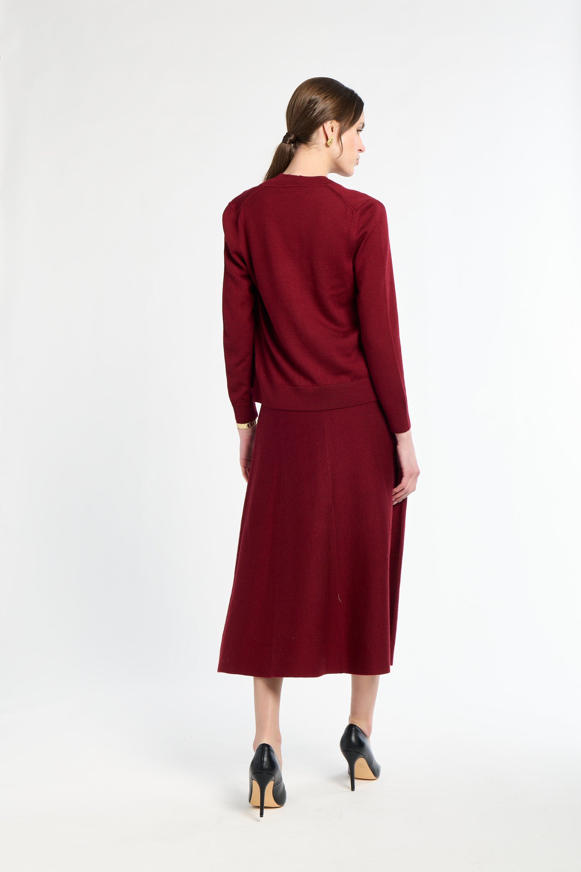 Woman wearing a burgundy dress on a white background