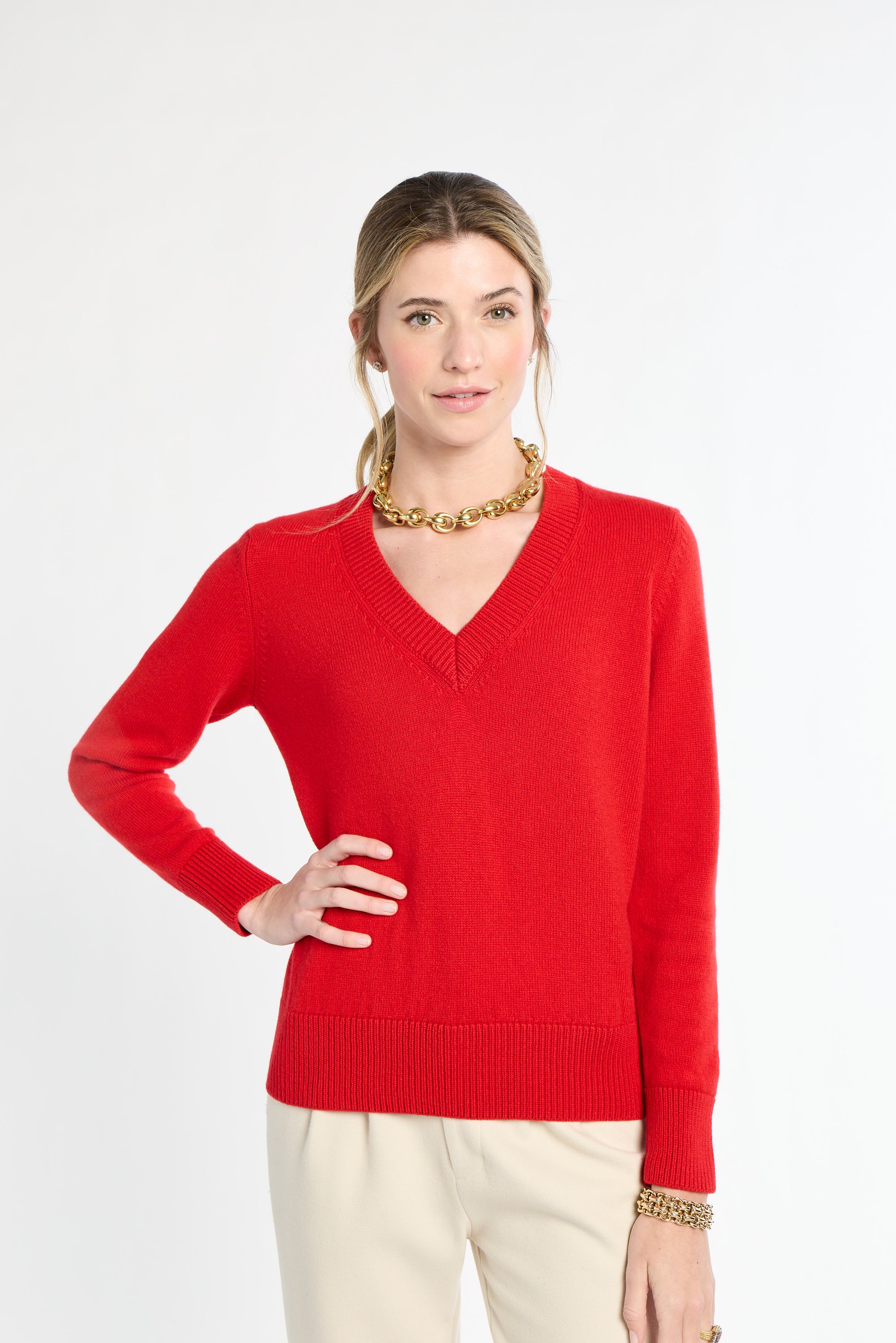 Woman wearing a red sweater on a white background