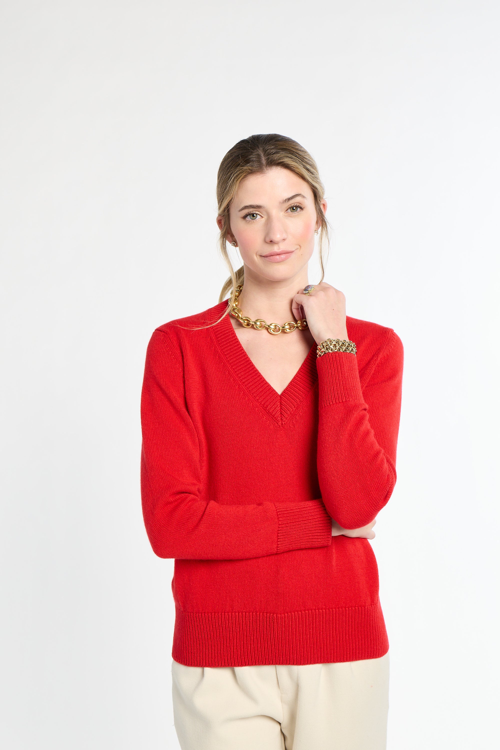 Woman wearing a red sweater on a white background